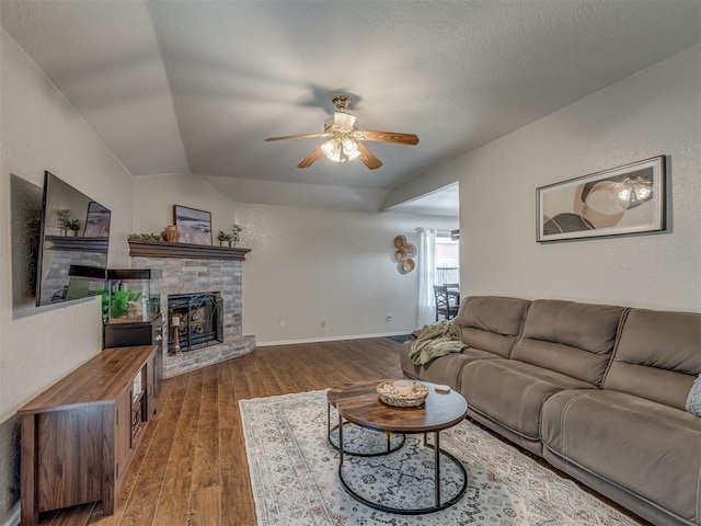 2009 Astoria Dr, Moore, OK 73160 - living room featuring ceiling fan, vaulted ceiling, wood finished floors, a fireplace, and baseboards