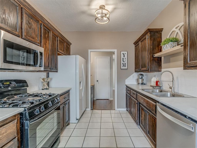 2009 Astoria Dr, Moore, OK 73160 - kitchen with appliances with stainless steel finishes, open shelves, a sink, decorative backsplash, and dark brown cabinetry