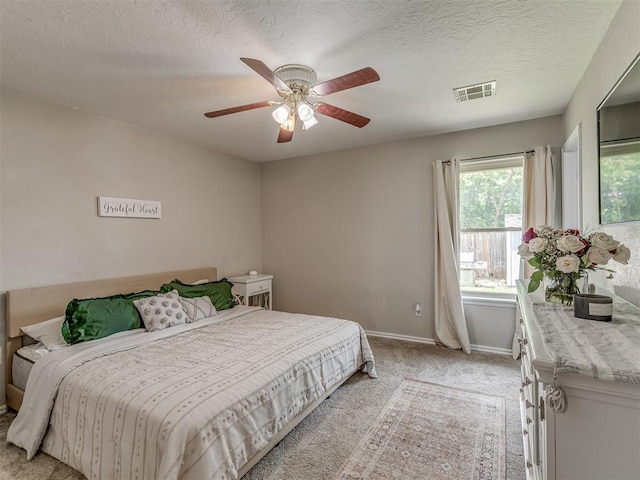 2009 Astoria Dr, Moore, OK 73160 - bedroom with light carpet, baseboards, a textured ceiling, and a ceiling fan