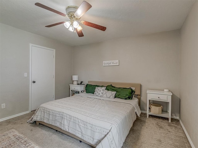 2009 Astoria Dr, Moore, OK 73160 - bedroom with carpet flooring, baseboards, and a ceiling fan