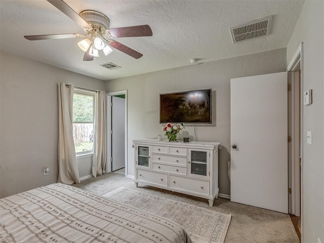 2009 Astoria Dr, Moore, OK 73160 - bedroom featuring light carpet, a textured ceiling, and a ceiling fan
