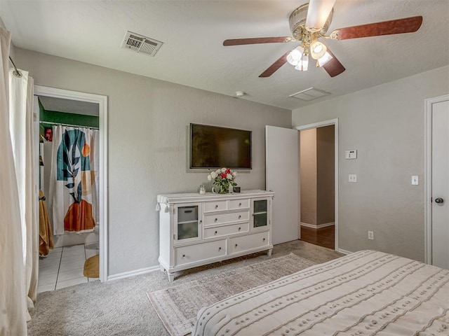 2009 Astoria Dr, Moore, OK 73160 - carpeted bedroom featuring a walk in closet, a closet, baseboards, ceiling fan, and tile patterned floors