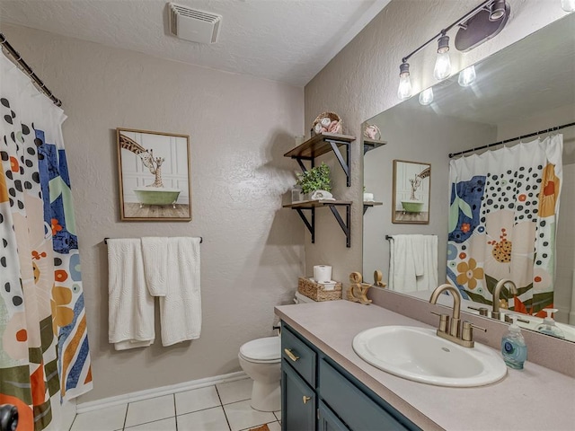 2009 Astoria Dr, Moore, OK 73160 - bathroom featuring tile patterned floors, toilet, vanity, a textured wall, and a textured ceiling