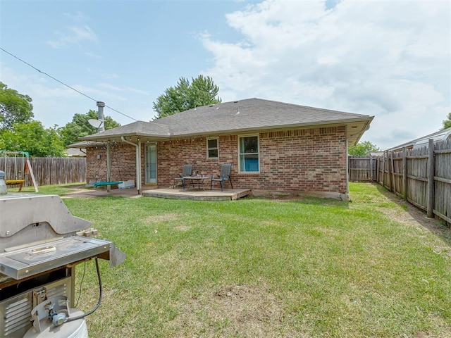 2009 Astoria Dr, Moore, OK 73160 - rear view of house with brick siding, a patio area, and a shingled roof