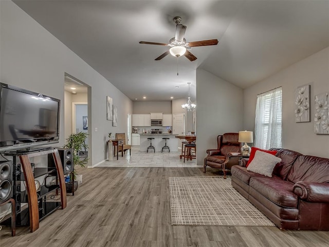 9120 SW 46th St, Oklahoma City, OK 73179 - living room with ceiling fan, light wood finished floors, vaulted ceiling, a chandelier, and baseboards