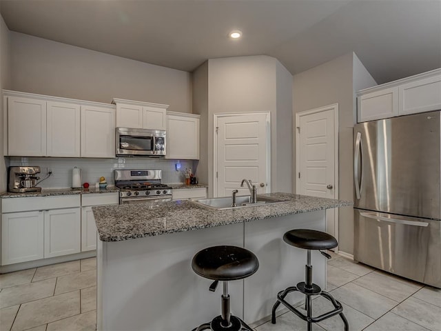 9120 SW 46th St, Oklahoma City, OK 73179 - kitchen with appliances with stainless steel finishes, a sink, tasteful backsplash, stone counters, and white cabinetry