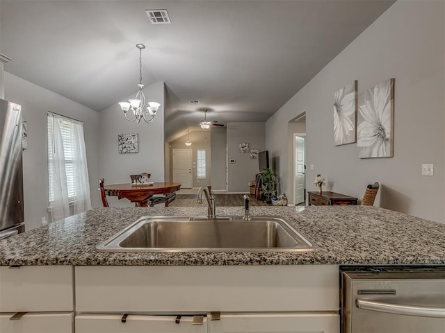 9120 SW 46th St, Oklahoma City, OK 73179 - kitchen featuring a sink, dishwasher, vaulted ceiling, ceiling fan, and a chandelier