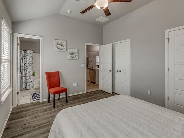 9120 SW 46th St, Oklahoma City, OK 73179 - bedroom with wood finished floors, vaulted ceiling, ensuite bath, a ceiling fan, and baseboards