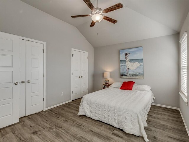 9120 SW 46th St, Oklahoma City, OK 73179 - bedroom with lofted ceiling, multiple closets, wood finished floors, baseboards, and multiple windows