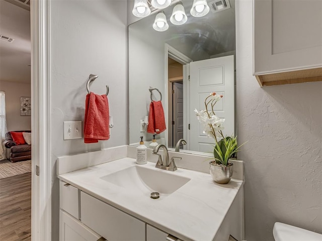 9120 SW 46th St, Oklahoma City, OK 73179 - bathroom with vanity, wood finished floors, and toilet