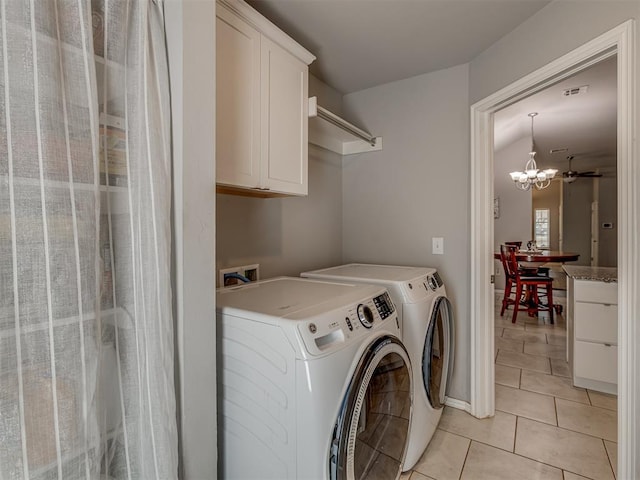 9120 SW 46th St, Oklahoma City, OK 73179 - laundry room featuring cabinet space, washer and dryer, light tile patterned floors, and a chandelier