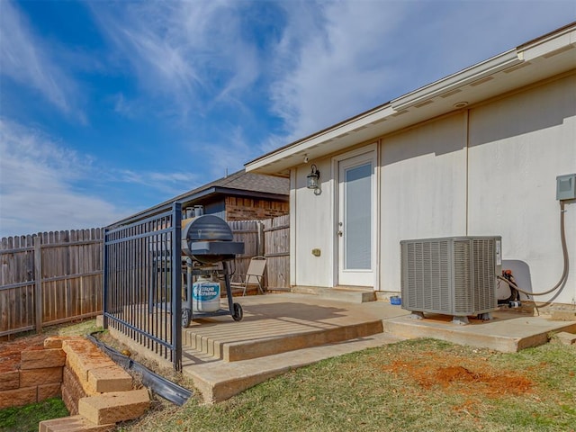 9120 SW 46th St, Oklahoma City, OK 73179 - wooden terrace with central AC unit, a fenced backyard, and a patio