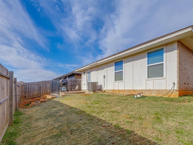 9120 SW 46th St, Oklahoma City, OK 73179 - back of house with cooling unit, board and batten siding, and brick siding
