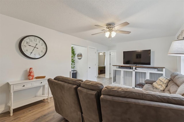 711 Spruce Dr, Yukon, OK 73099 - living room featuring wood finished floors, a ceiling fan, and a textured ceiling