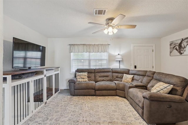 711 Spruce Dr, Yukon, OK 73099 - living room with ceiling fan, a textured ceiling, and wood finished floors
