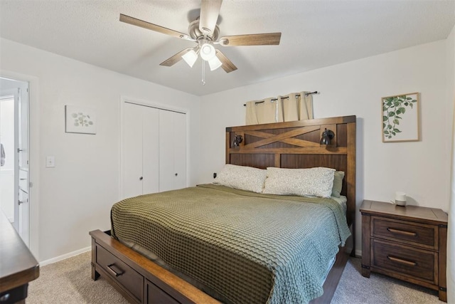 711 Spruce Dr, Yukon, OK 73099 - bedroom with a closet, light colored carpet, a ceiling fan, and baseboards