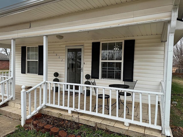 view of exterior entry featuring covered porch