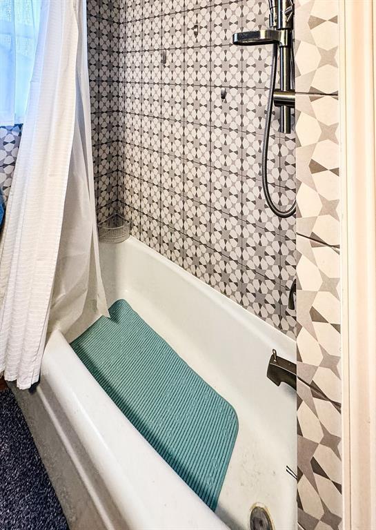 full bath featuring shower / bath combination with curtain