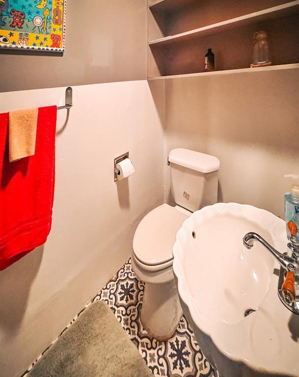 half bathroom featuring toilet and a sink