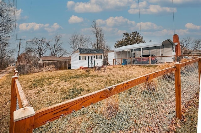view of yard with an outdoor structure and a detached carport