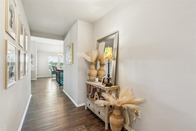 3432 Piney River Dr, Yukon, OK 73099 - hall featuring wood finished floors, baseboards, and a chandelier