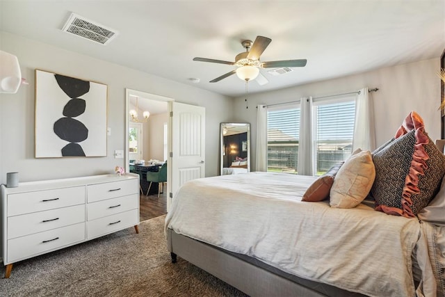 3432 Piney River Dr, Yukon, OK 73099 - bedroom with a chandelier and a ceiling fan