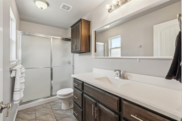 3432 Piney River Dr, Yukon, OK 73099 - bathroom featuring toilet, a stall shower, and vanity