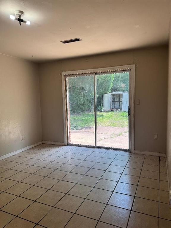 3316 Beechwood Dr, Del City, OK 73115 - spare room with light tile patterned floors and baseboards