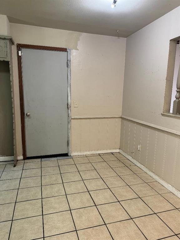 3316 Beechwood Dr, Del City, OK 73115 - spare room with a wainscoted wall