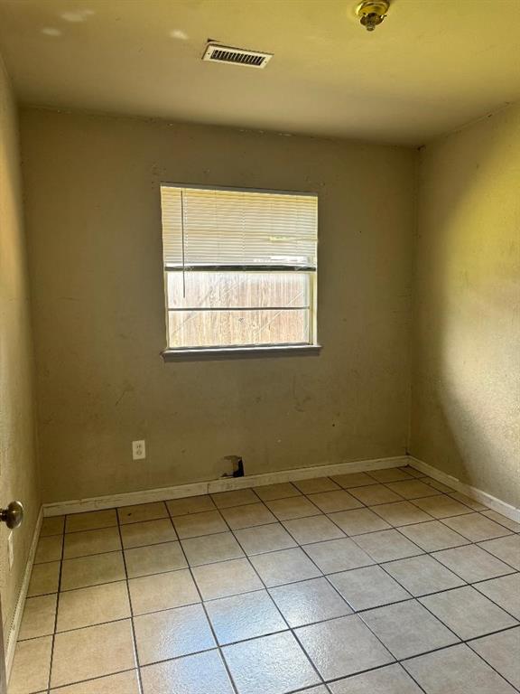 3316 Beechwood Dr, Del City, OK 73115 - empty room with light tile patterned floors and baseboards