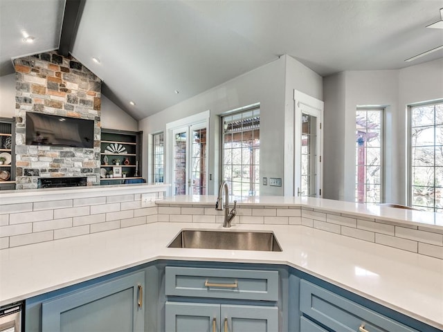 kitchen featuring a sink, open floor plan, light countertops, gray cabinetry, and blue cabinets