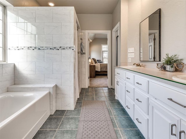 full bath featuring a garden tub, ensuite bath, and double vanity
