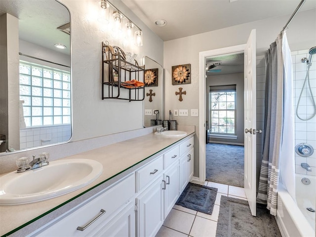 full bathroom with double vanity, tile patterned floors, and shower / tub combo