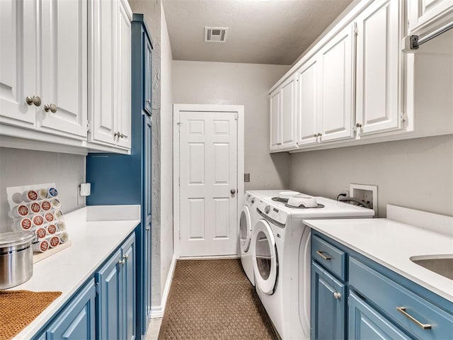 laundry area featuring cabinet space and washer and clothes dryer