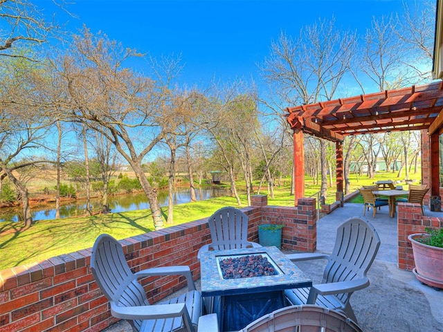 view of patio with a fire pit, a pergola, and a water view