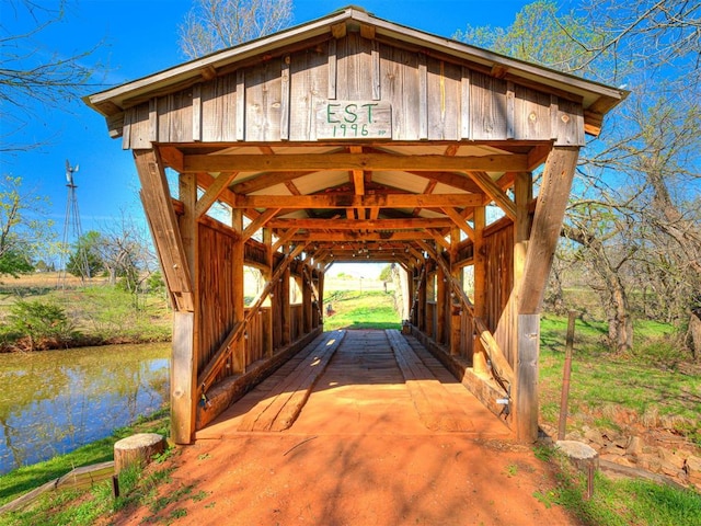 view of community featuring a gazebo, a water view, and a carport