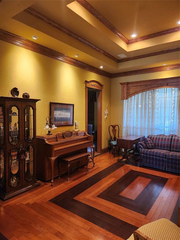 11301 Brockton Pl, Oklahoma City, OK 73162 - living room featuring ornamental molding, a raised ceiling, and wood finished floors