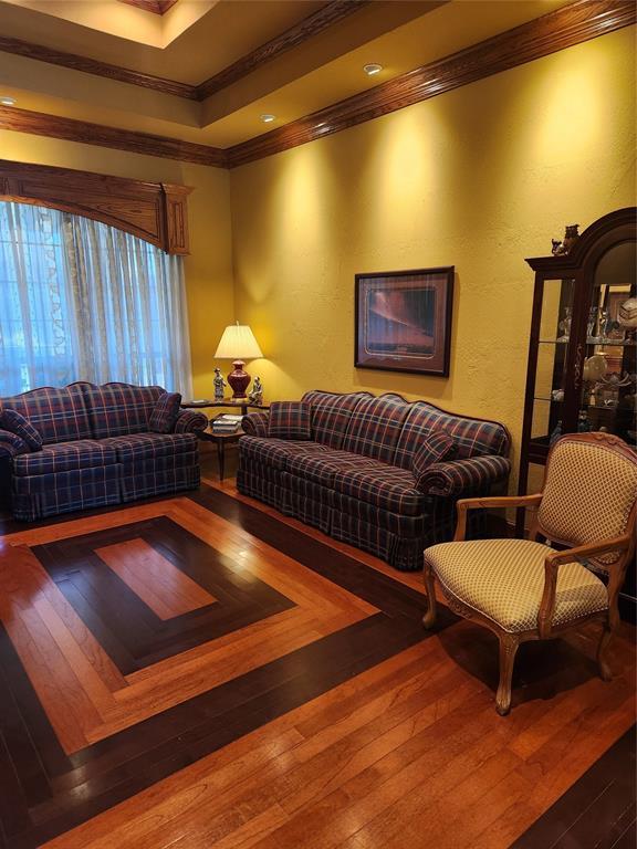 11301 Brockton Pl, Oklahoma City, OK 73162 - living room featuring ornamental molding, hardwood / wood-style floors, and a tray ceiling