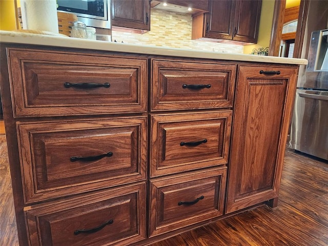 11301 Brockton Pl, Oklahoma City, OK 73162 - detailed view of stainless steel appliances, decorative backsplash, and wood finished floors