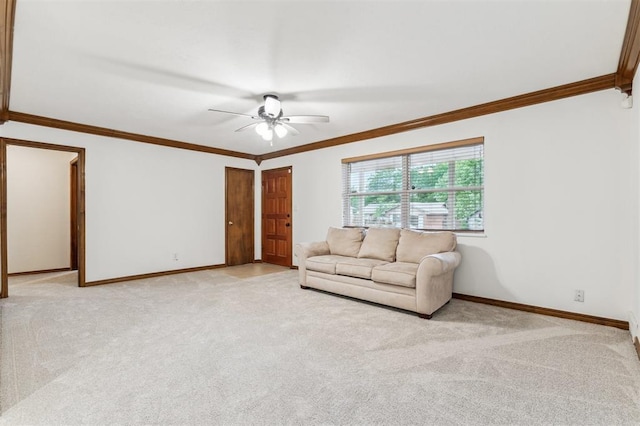 living area with crown molding, baseboards, light colored carpet, and a ceiling fan