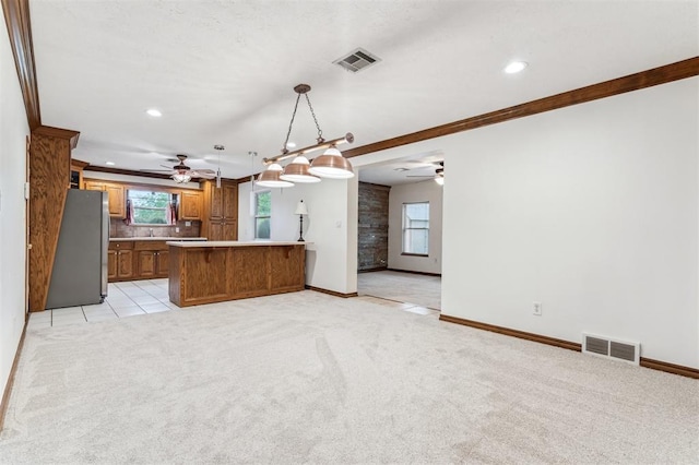 kitchen featuring a ceiling fan, freestanding refrigerator, open floor plan, brown cabinets, and recessed lighting