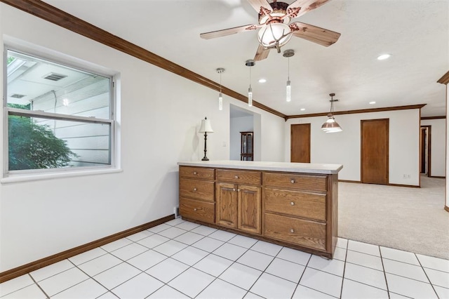 kitchen featuring a peninsula, brown cabinetry, baseboards, ornamental molding, and ceiling fan
