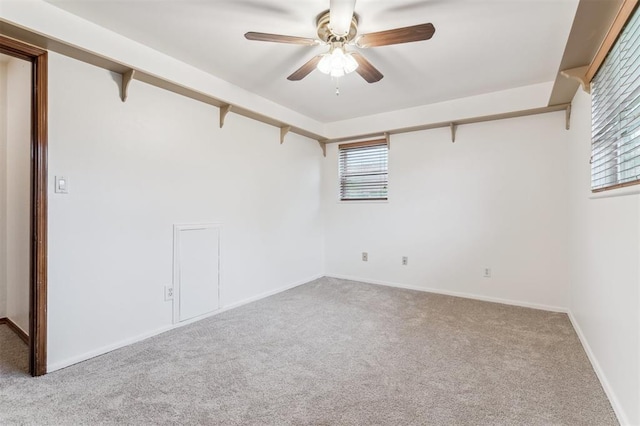 spare room with carpet, ceiling fan, and baseboards