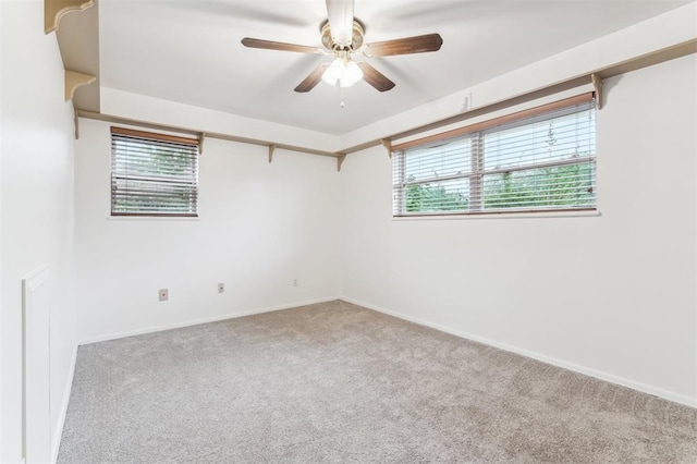 unfurnished room featuring carpet, ceiling fan, and baseboards
