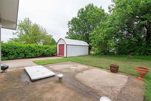 view of patio with a storage shed and an outbuilding