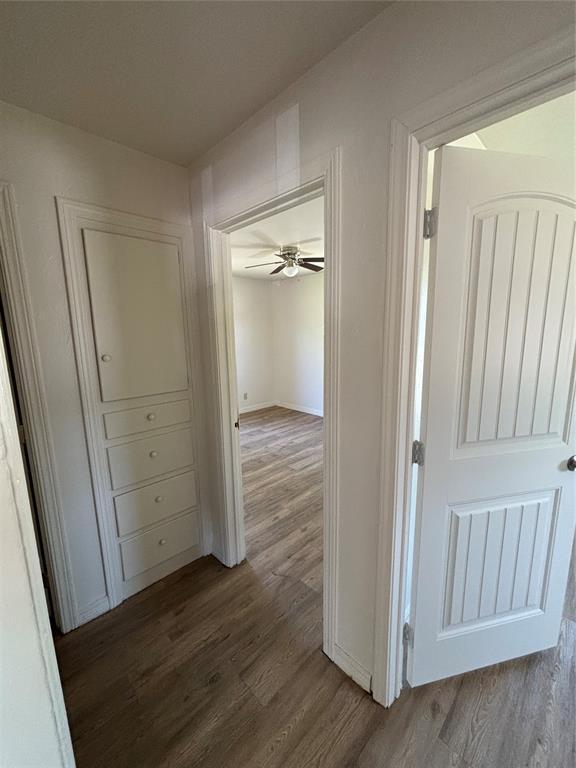 1011 E Sutherland St, Altus, OK 73521 - corridor featuring dark wood-style floors