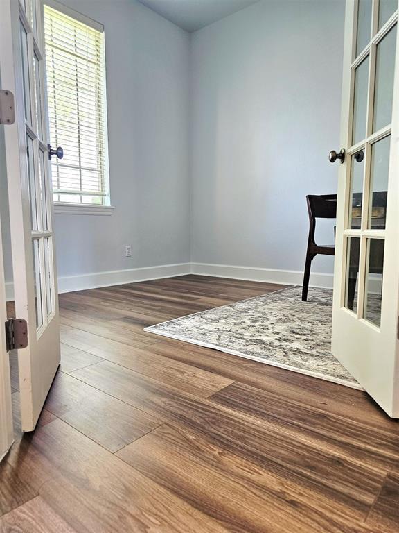 12401 SW 7th St, Yukon, OK 73099 - empty room featuring baseboards and wood finished floors