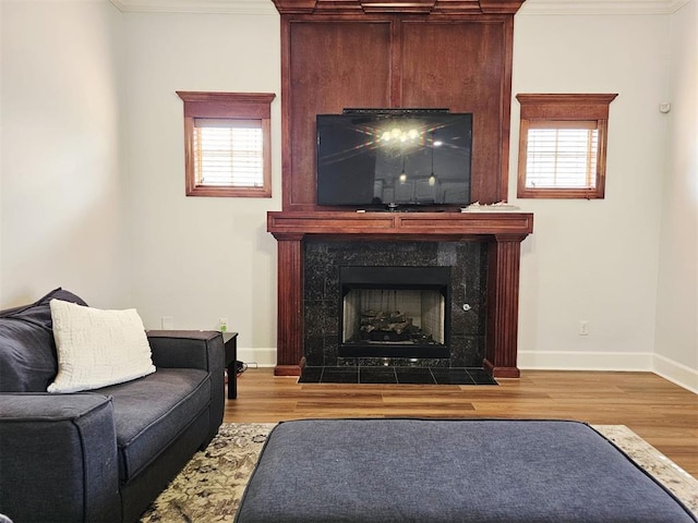 12401 SW 7th St, Yukon, OK 73099 - living room featuring crown molding, wood finished floors, a premium fireplace, and healthy amount of natural light