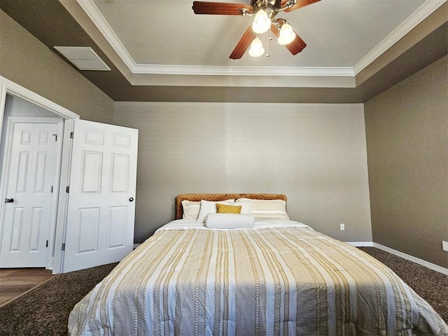12401 SW 7th St, Yukon, OK 73099 - bedroom with a tray ceiling, ornamental molding, baseboards, carpet flooring, and ceiling fan