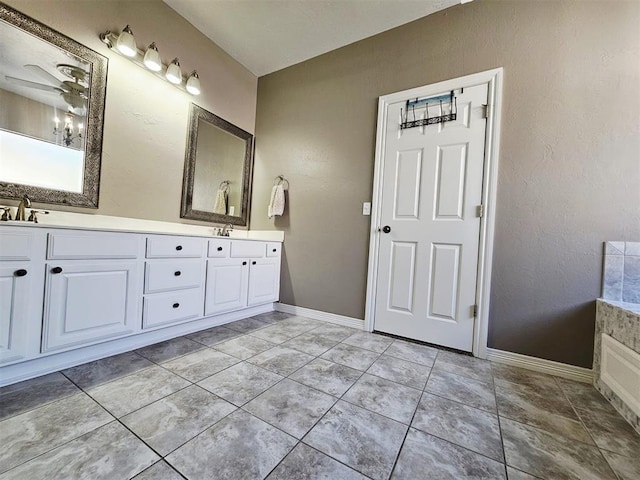 12401 SW 7th St, Yukon, OK 73099 - full bathroom with double vanity, a ceiling fan, baseboards, and tile patterned floors